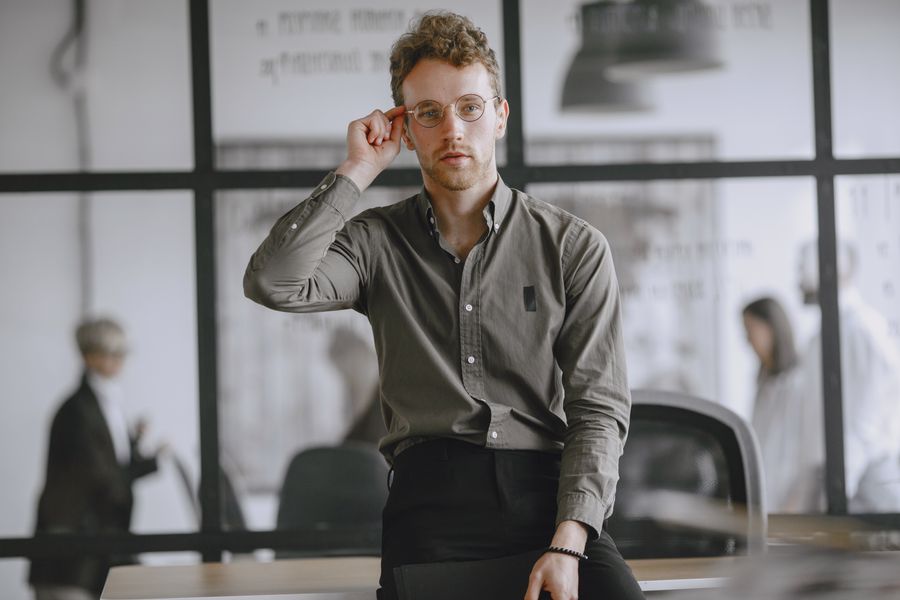 Illustrative portrait of a person wearing glasses in an office, used for the translational-science design persona.