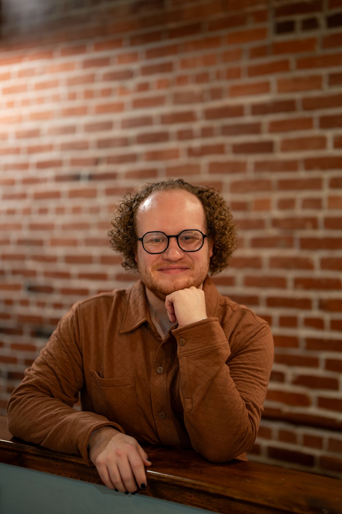 Illustrative portrait of a person in a bar, used for the connected regular design persona.