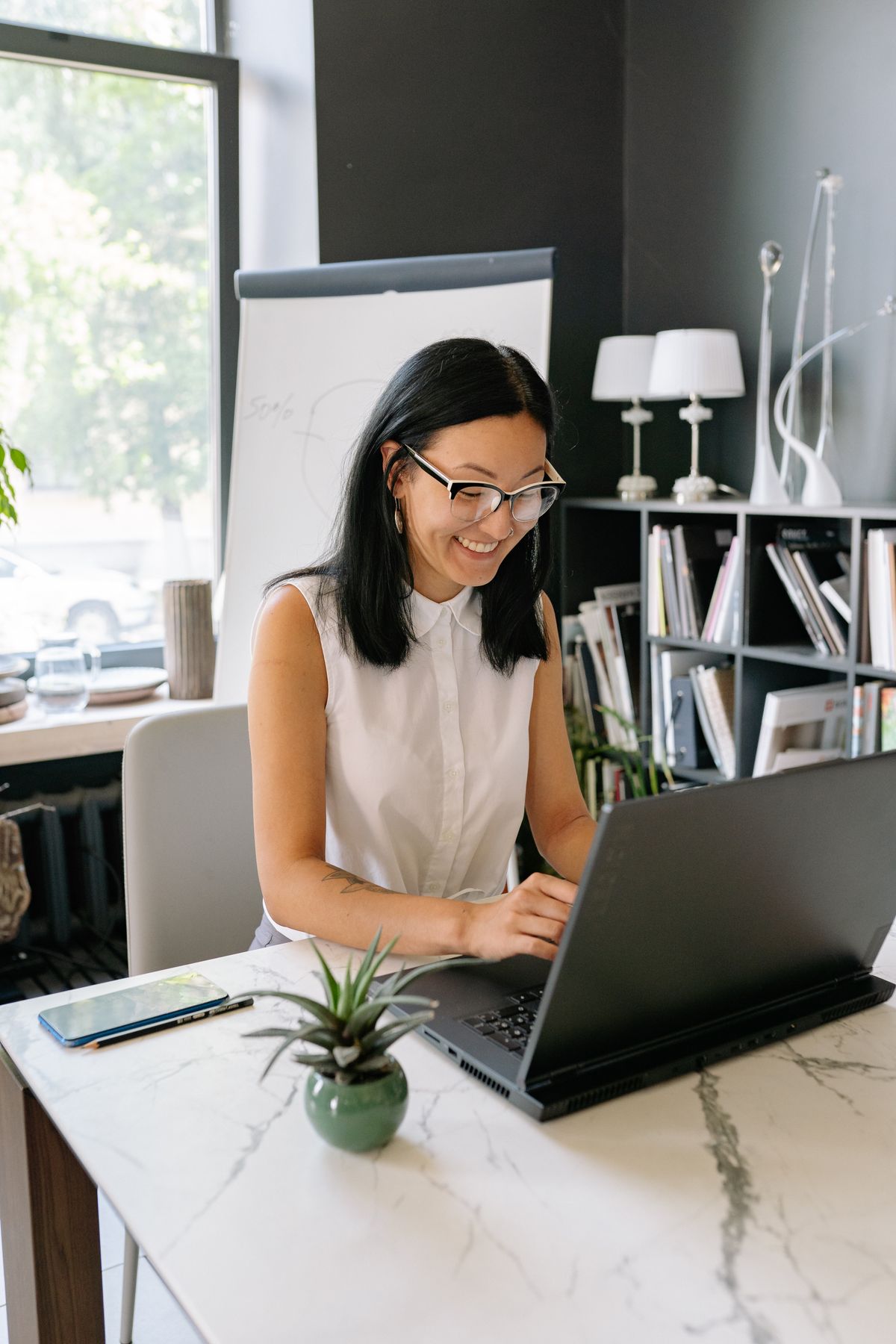 Illustrative portrait of a person working at a laptop, used for the experience optimiser design persona.